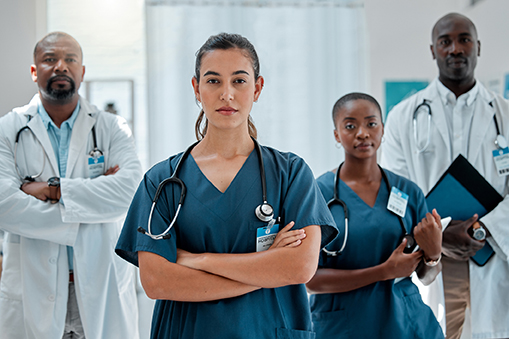 Group of serious diverse doctors standing with their arms crossed while working at a hospital. Focused expert medical professionals at work together at a clinic
